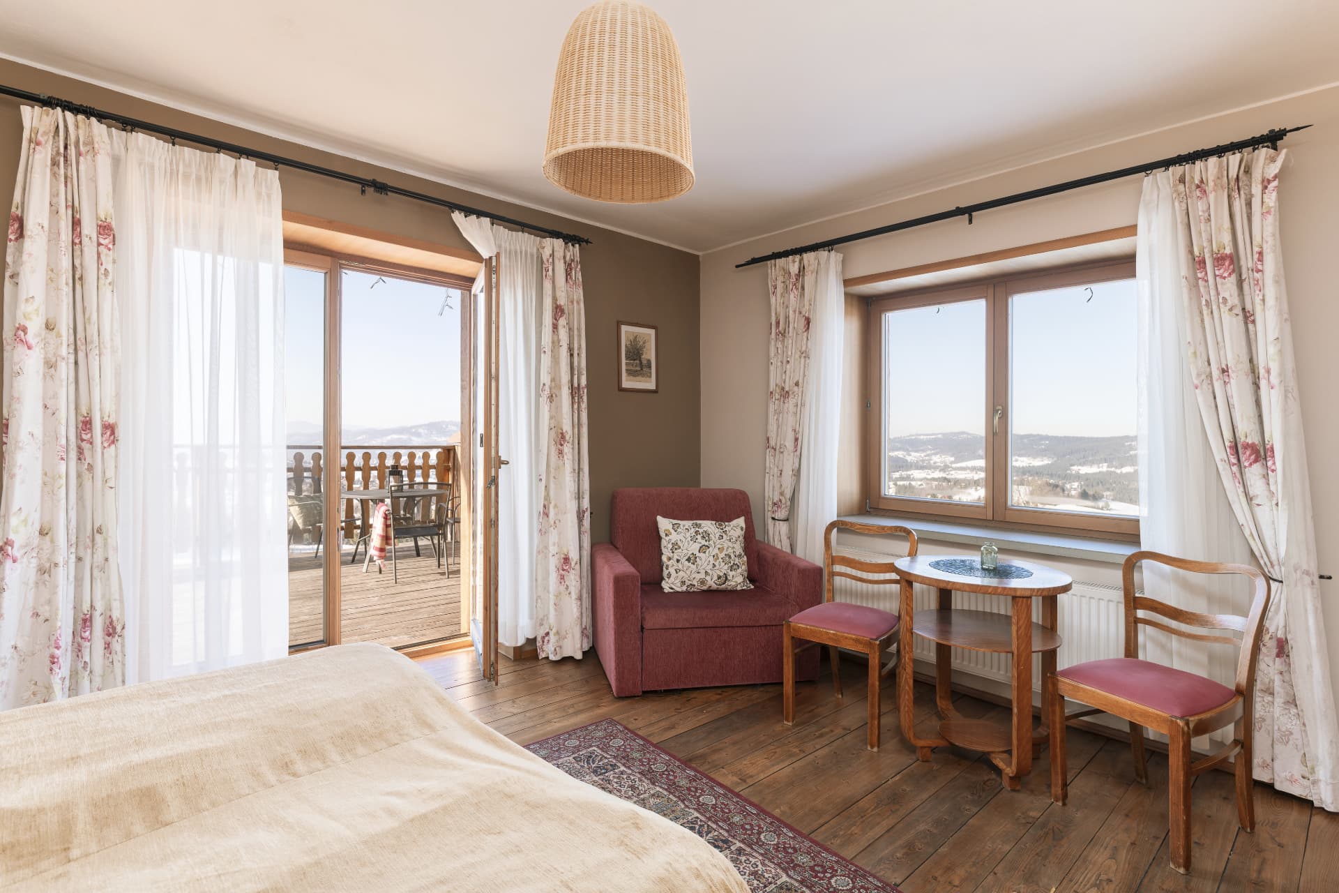 Deluxe Double Room with open balcony doors and mountain view