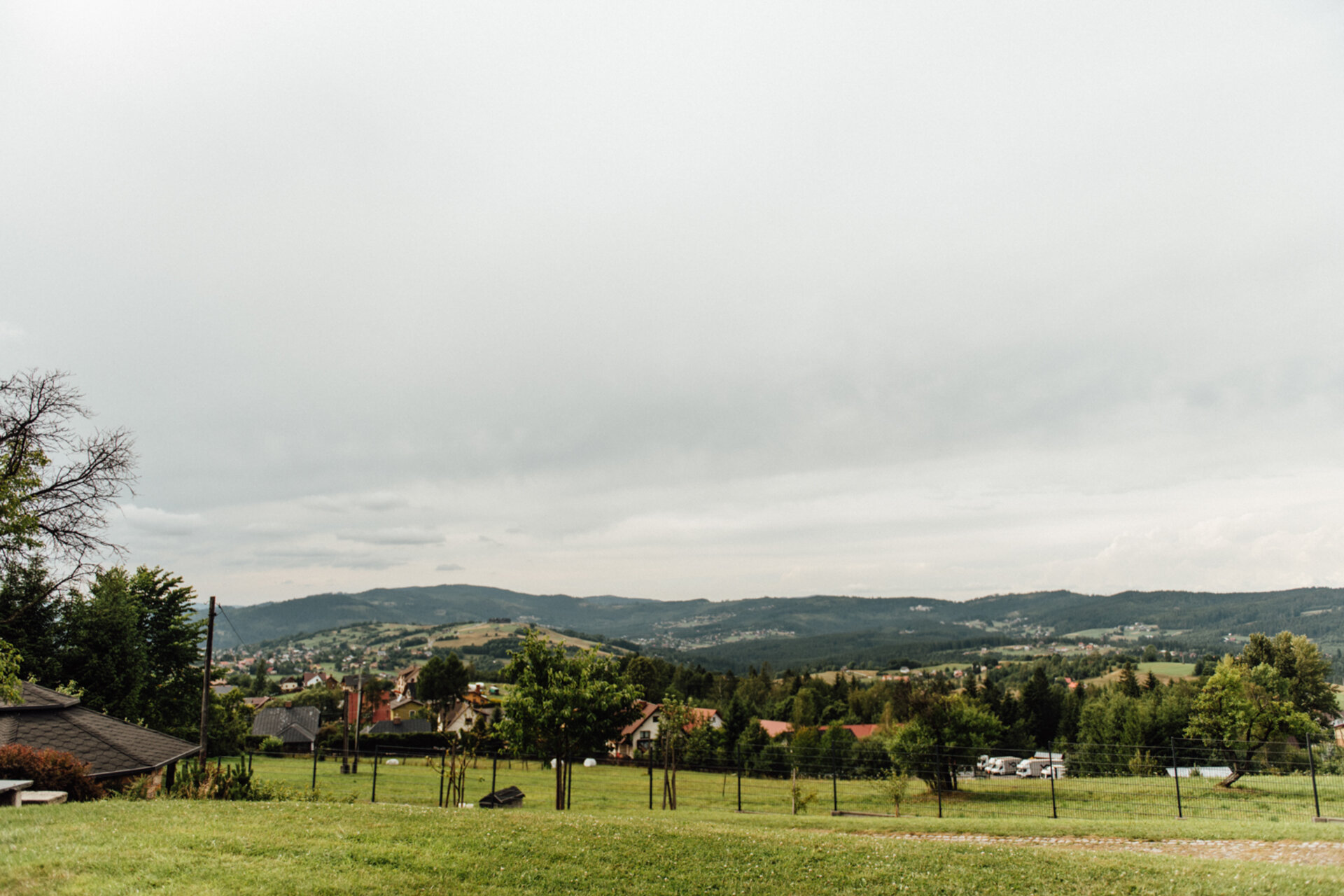 View over the village and green hills from the garden in summer
