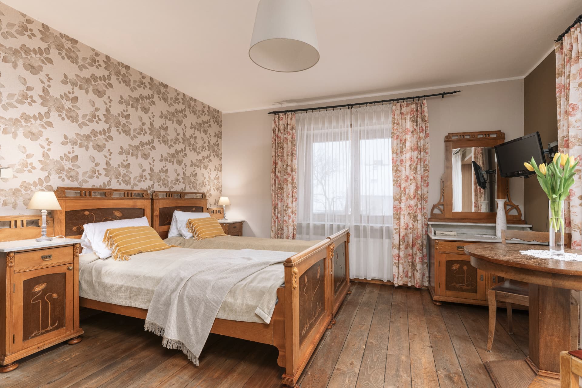 Two twin beds and a vanity in room 3