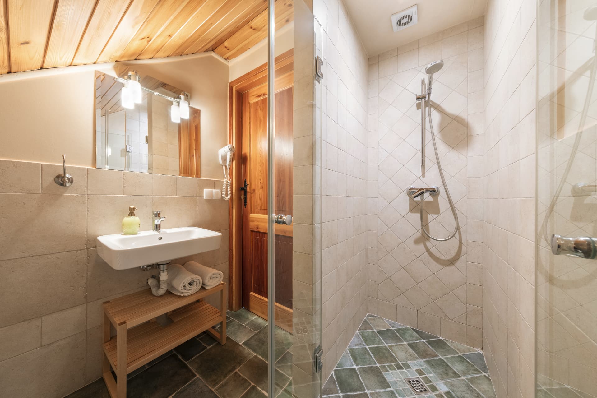 Bathroom of room 8 with a walk-in shower and a sink on a wooden stand