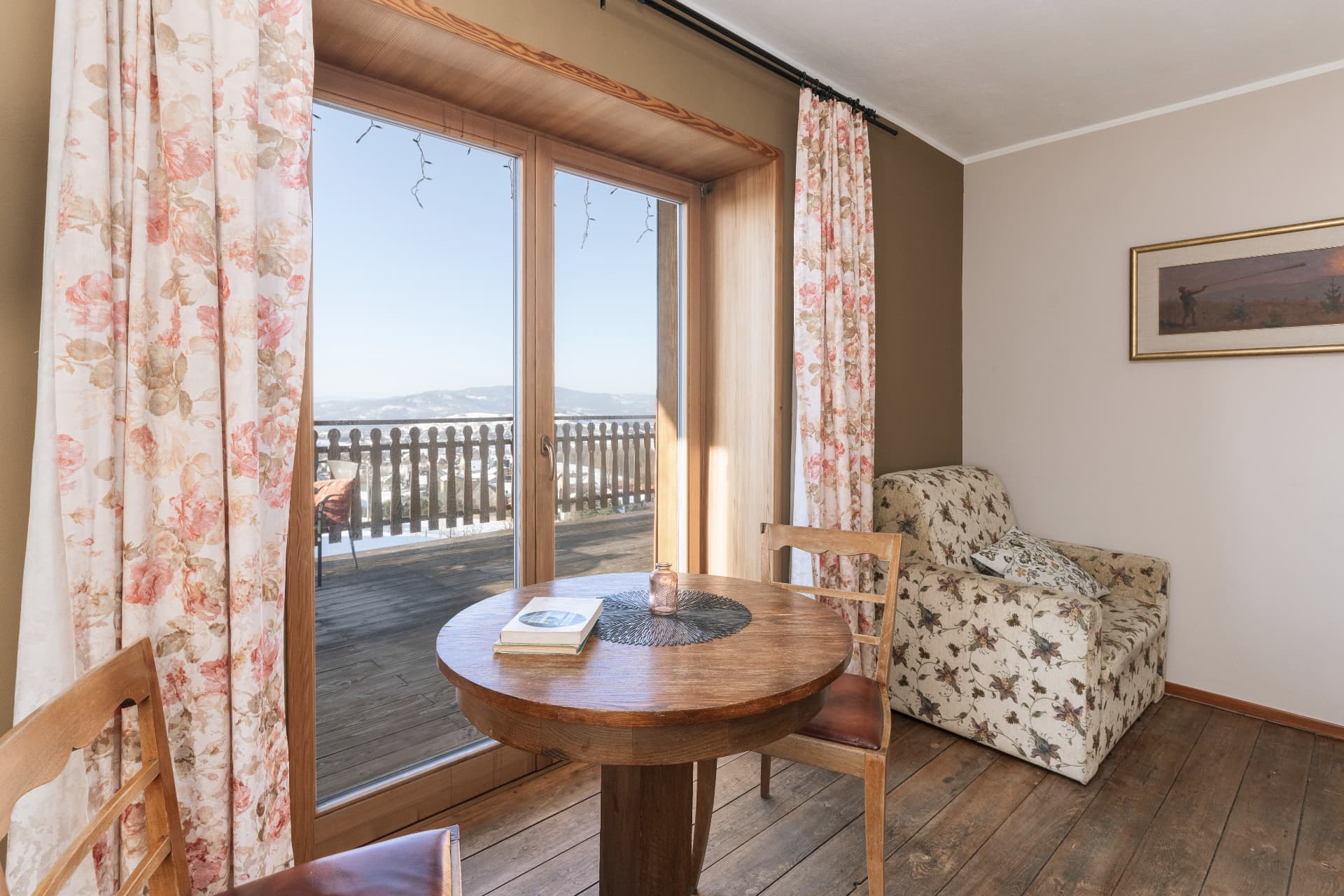 Sitting corner with armchair and balcony doors in room 3