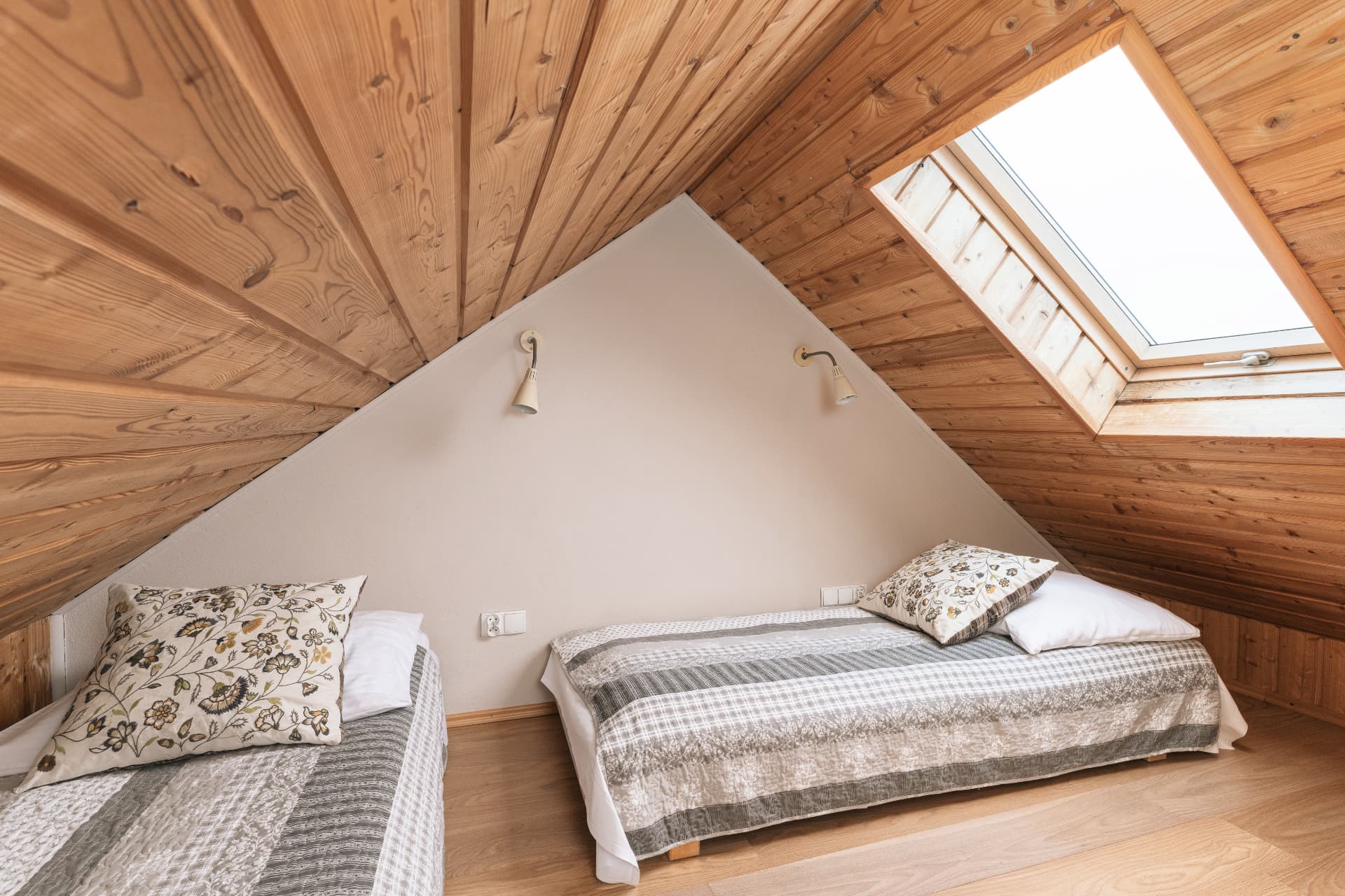 Attic sleeping space of room 9 with two single beds and a skylight