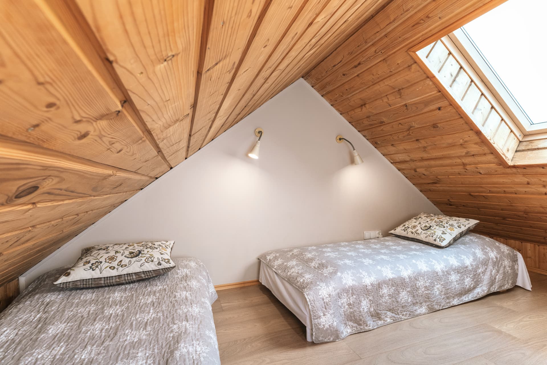 Upper sleeping area of room 8 with two single beds under a skylight