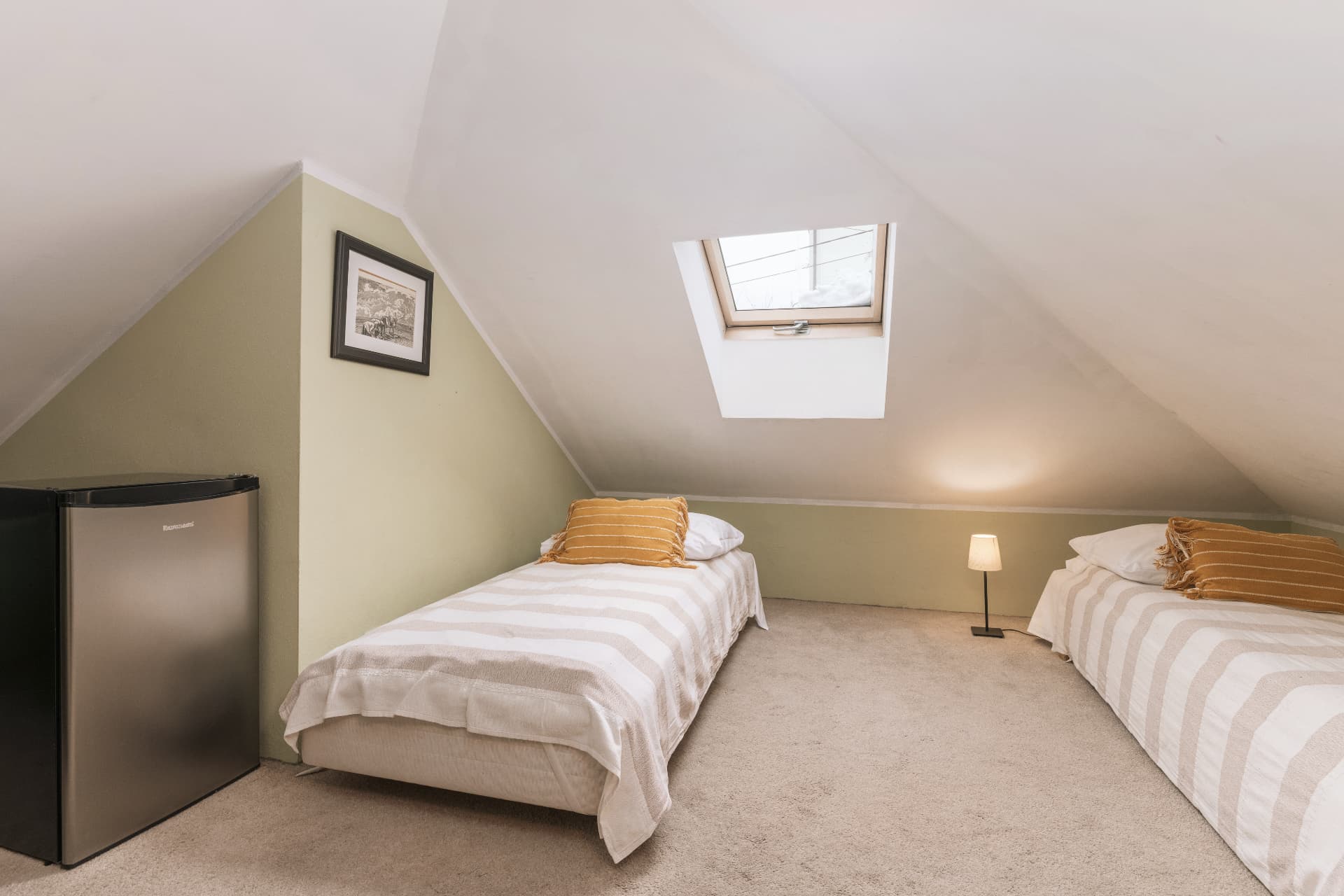 Adjoining attic bedroom of room 6 with two single beds and a skylight