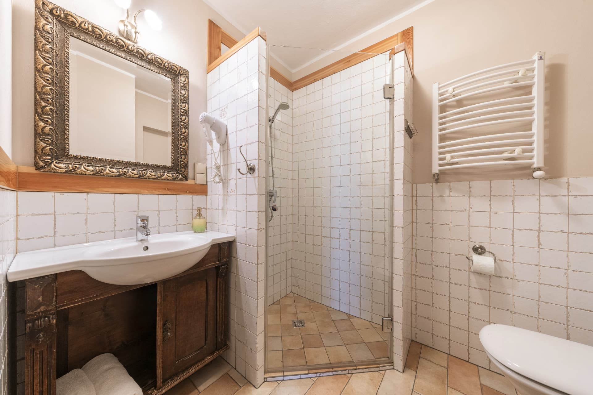 Bathroom of room 5 with a rustic wooden vanity sink and ornate mirror